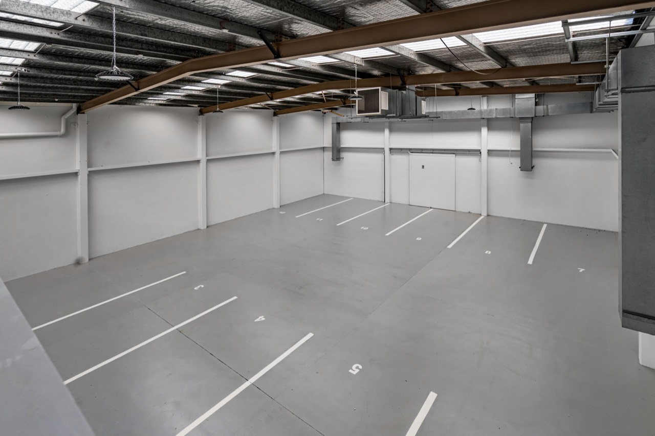 Numbered car parks inside the ground-floor garage